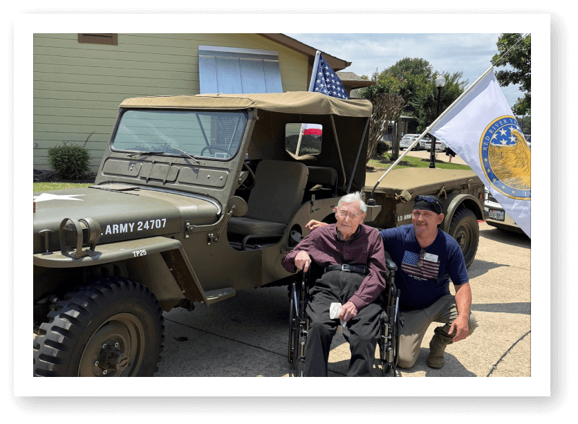 Elderly Veteran in Wheelchair Beside Military Jeep at Assisted Living Facility