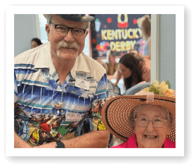 Elderly Man and Woman Celebrating Kentucky Derby Themed Event at Assisted Living Facility