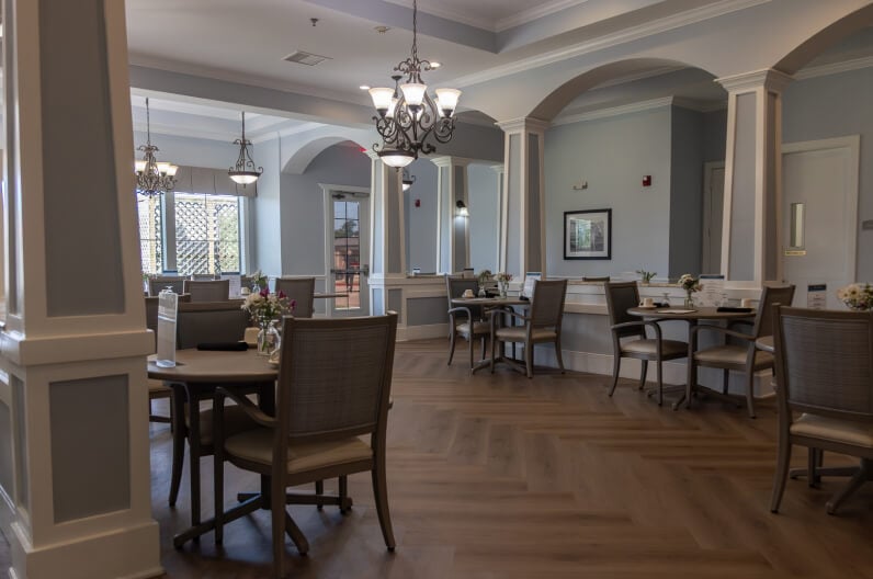 Formal Dining Room with Chandeliers and Arched Columns for Seniors at Assisted Living Facility Formal Dining Room with Chandeliers and Arched Columns for Seniors at Assisted Living Facility