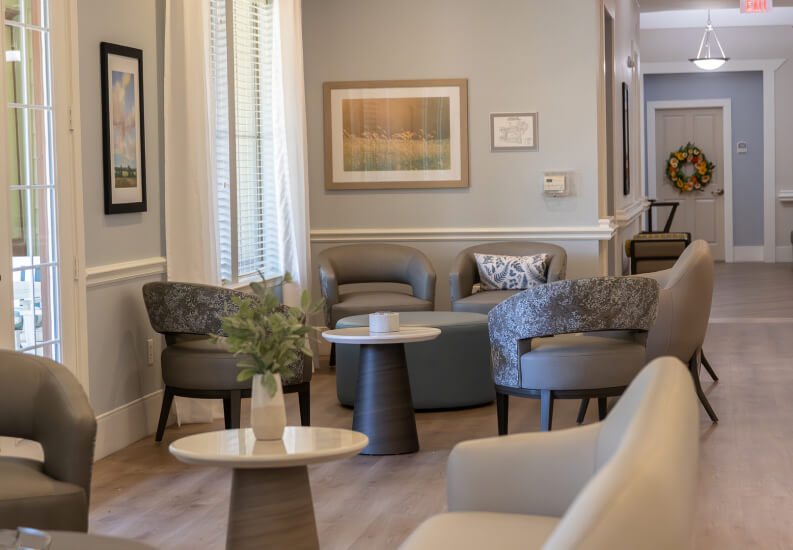 Memory Care Lounge Sitting Area with Hallway View for Seniors at Memory Care Facility