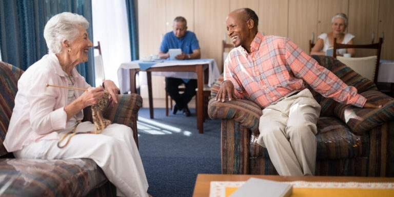 Elderly Residents Chatting in Comfortable Lounge at Assisted Living Facility